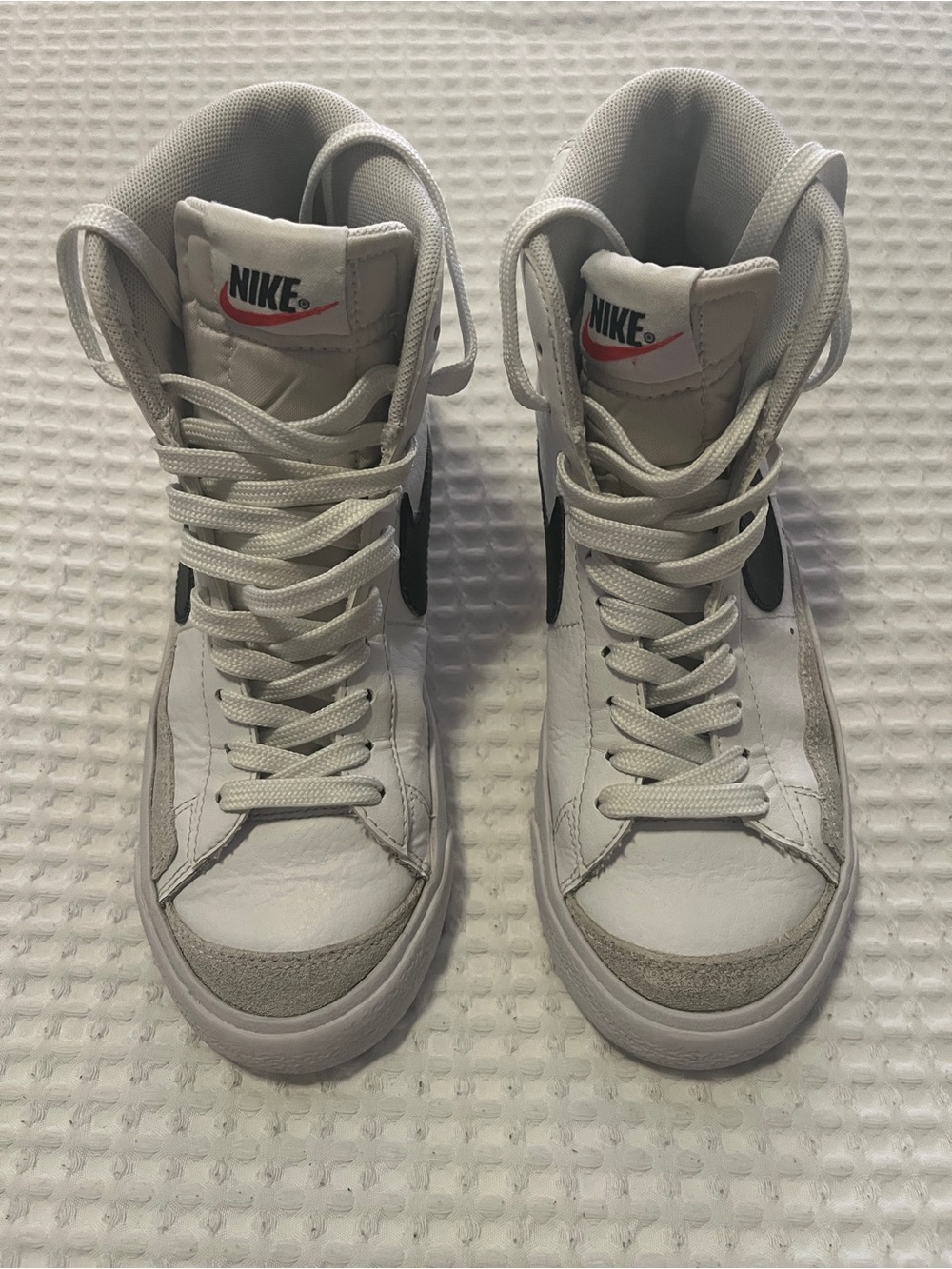 Nike White High-Top Sneakers with Black Swoosh